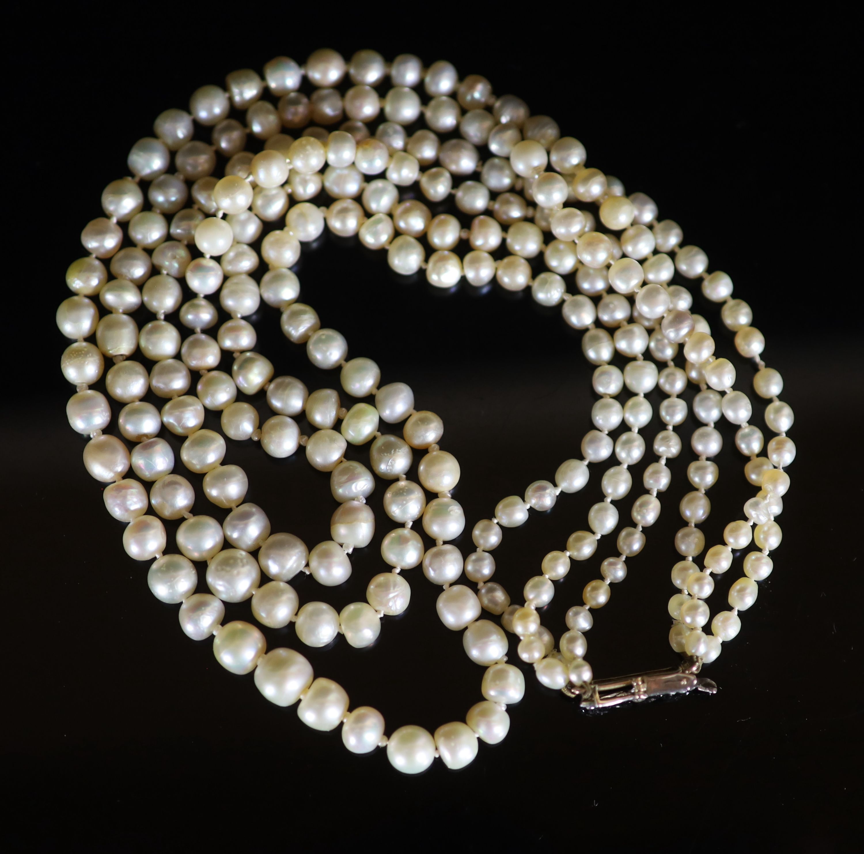 A three-row graduated pearl necklace with diamond-set openwork yellow metal clasp